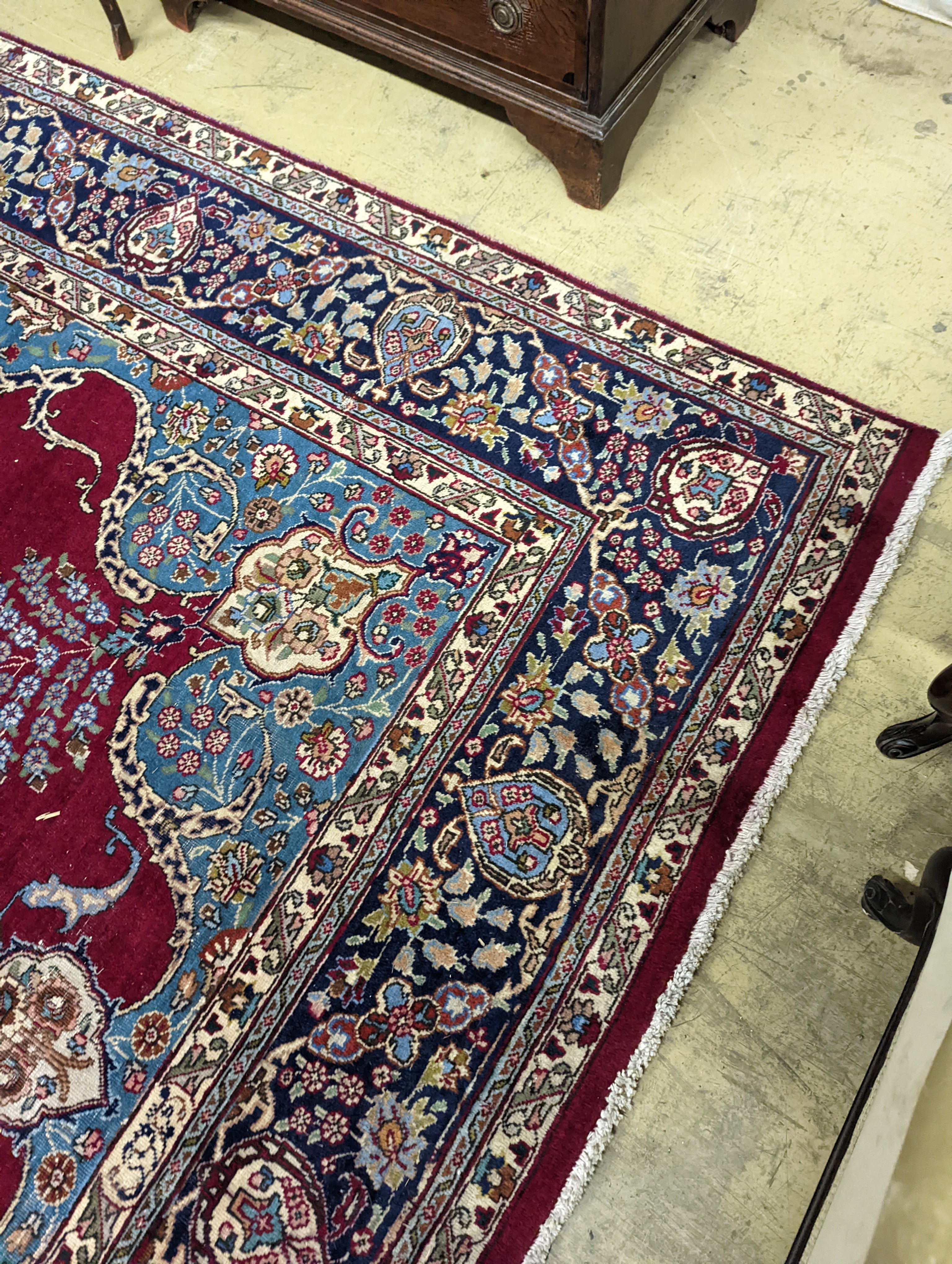A Tabriz burgundy ground carpet, 350 x 240cm